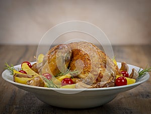 Roast chicken and various vegetables on a white plate