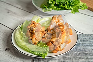 Roast chicken wring on the wooden table