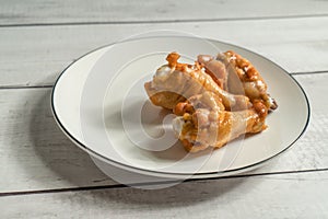 Roast chicken wring on the wooden table