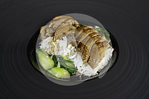 Roast Duck with rice and vegetable in black plate