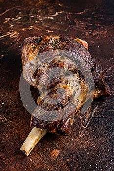 Roast Lamb leg with herbs and garlic. Dark background. Top view