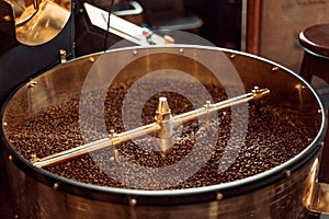 Roast machine. The freshly roasted coffee beans from a coffee roaster being poured into the cooling cylinder.
