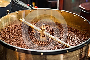 Roast machine. The freshly roasted coffee beans from a coffee roaster being poured into the cooling cylinder.