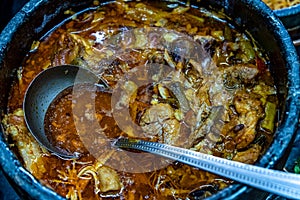 roast meat in a pot on the dinner table