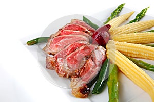 Roast meat served with corns