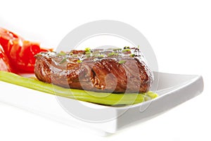 Roast meat served with tomato