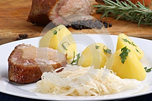 Roast pork with boiled potatoes and sauerkraut