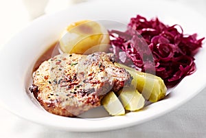 Roast pork chop with potato dumplings and red cabbage