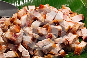 Roast pork cut into pieces on palm leaf