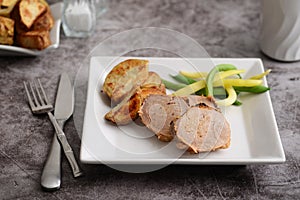 Roast pork dinner with knife and fork