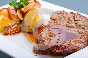 Roast pork with gravy and potatoes