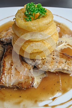 Roast pork in mushroom sauce with onion ring