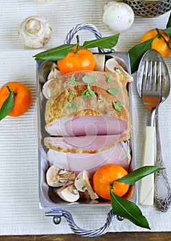 Roast pork with mushrooms and tangerines