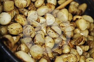 Roast potatoes seasoned with provencial herbs in a pan