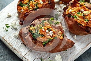 Roast sweet potato stuffed with feta cheese and kale. healthy food