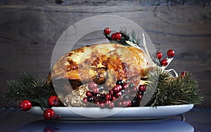 Roast turkey against dark rustic wood background.