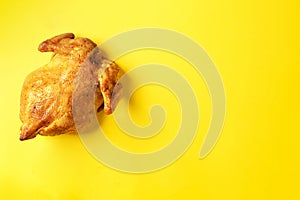 Roast whole turkey or chicken on yellow background. Top view. Food pattern. Festive family dinner. Thanksgiving day concept