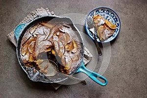 Roasted apple clafoutis (French custard cake) in cast iron pan