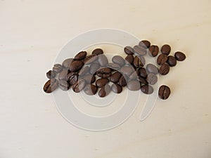 Roasted Arabian coffee beans on a wooden board