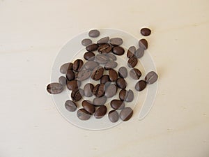 Roasted Arabian coffee beans on a wooden board