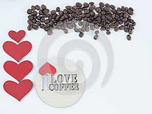 Roasted arome scattered coffee beans, red little hearts and coster with inscription I love coffee isolated on white