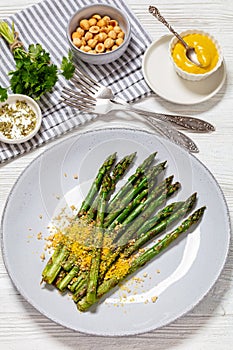 roasted asparagus with nut yeast crumble on plate