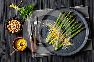 roasted asparagus with nut yeast crumble on plate