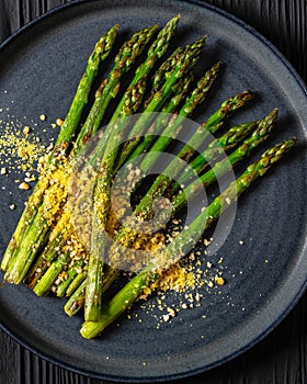 roasted asparagus with nut yeast crumble on plate