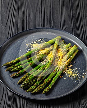 roasted asparagus with nut yeast crumble on plate