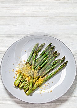 roasted asparagus with nut yeast crumble on plate