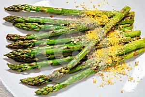 roasted asparagus with nut yeast crumble on plate