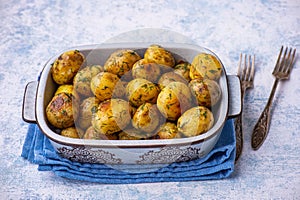 Roasted baby potatoes with garlic and herb, on light background