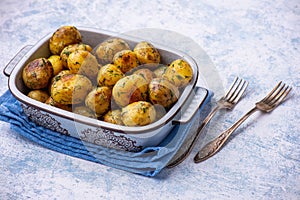 Roasted baby potatoes with garlic and herb, on light background