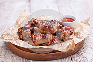 Roasted barbecue chicken wings with bbq sauce, italian herbs, olive oil and pepper