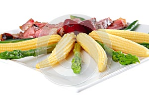 Roasted beef served with corns