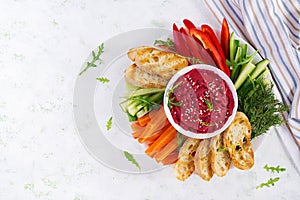 Roasted beet hummus with toast and vegetables. Beetroot hummus.