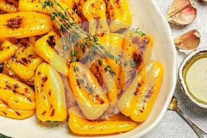 Roasted bell pepper with olive oil, garlic, thyme and spices close up