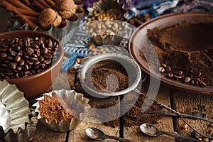 Roasted black and green coffee beans and ground coffee in the plate