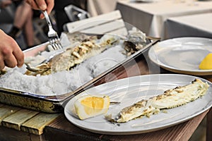 Roasted Branzino or sea bass filleted at a table, Vernazza, Cinque Terre Italy