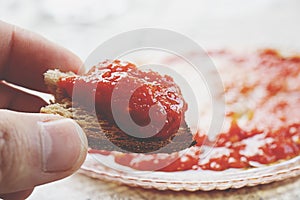 Roasted Bread, Tomato Sauce Close Up on a Kitchen Table