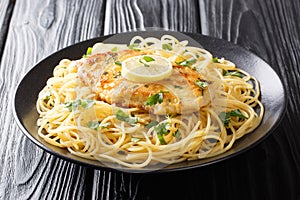 Roasted breaded chicken Francaise with a side dish of spaghetti close-up on a plate. Horizontal photo