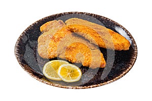 Roasted breaded german weiner schnitzel on a plate. Isolated on white background. Top view.