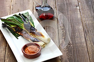 Roasted calcots with romesco sauce for dipping photo