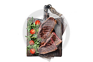 Roasted cap rump or Top sirloin beef meat steak on wooden board with salad. Isolated on white background.