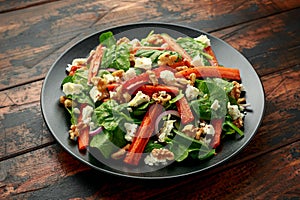 Roasted carrot salad with feta cheese, walnut and spinach. healthy food