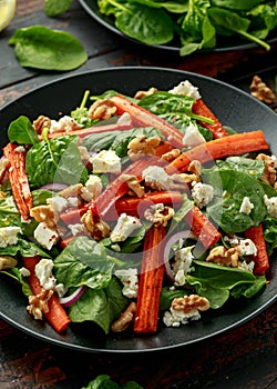 Roasted carrot salad with feta cheese, walnut and spinach. healthy food