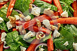 Roasted carrot salad with feta cheese, walnut and spinach. healthy food
