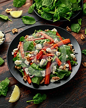 Roasted carrot salad with feta cheese, walnut and spinach. healthy food