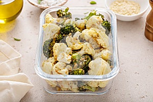 Roasted cauliflower and broccoli in a meal prep container, healthy vegetable side dish