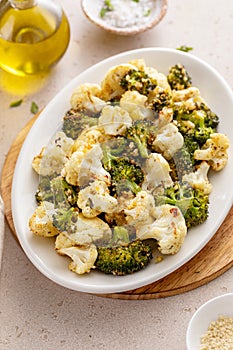 Roasted cauliflower and broccoli on a serving plate, healthy vegetable side dish